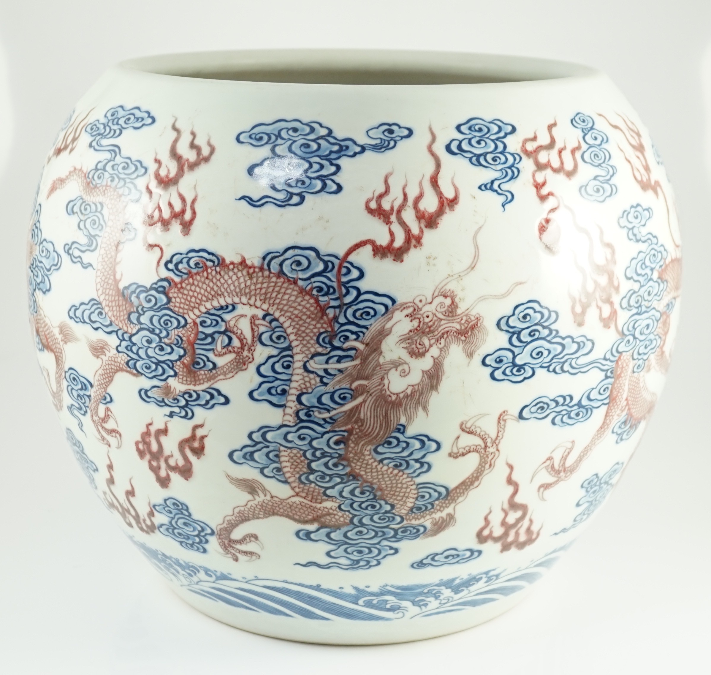 A large Chinese underglaze blue and copper red 'dragon' scroll vessel, 42.5cm diameter, 34.5cm high